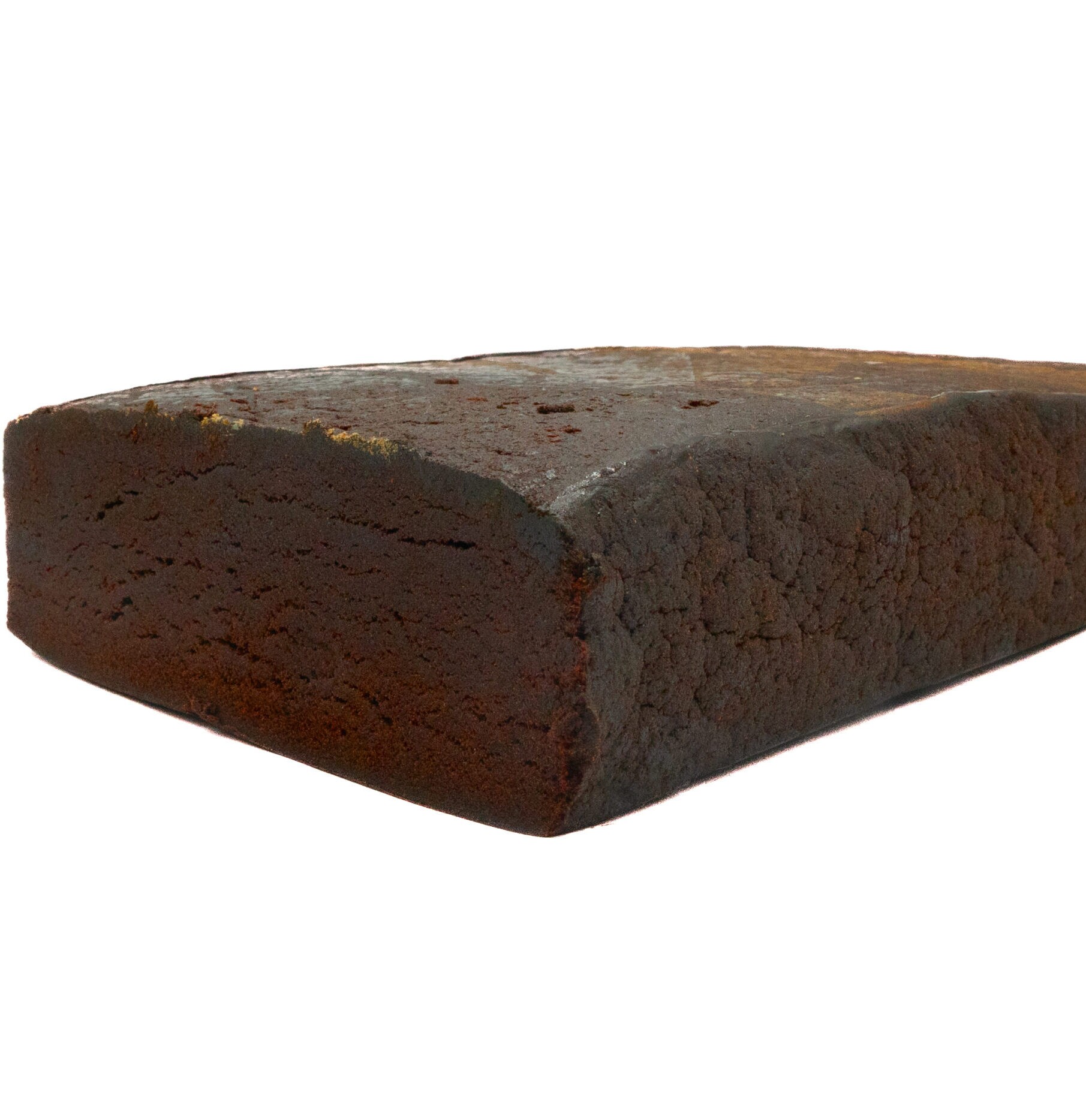 A close-up of a large, rectangular loaf of dark brown rye bread with a dense texture and slightly rough surface, reminiscent of the rich color and crumbly appearance of RED LEBANESE HASH.